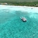 A catamaran cruises on the water off Kuza Beach in Cozumel, Mexico